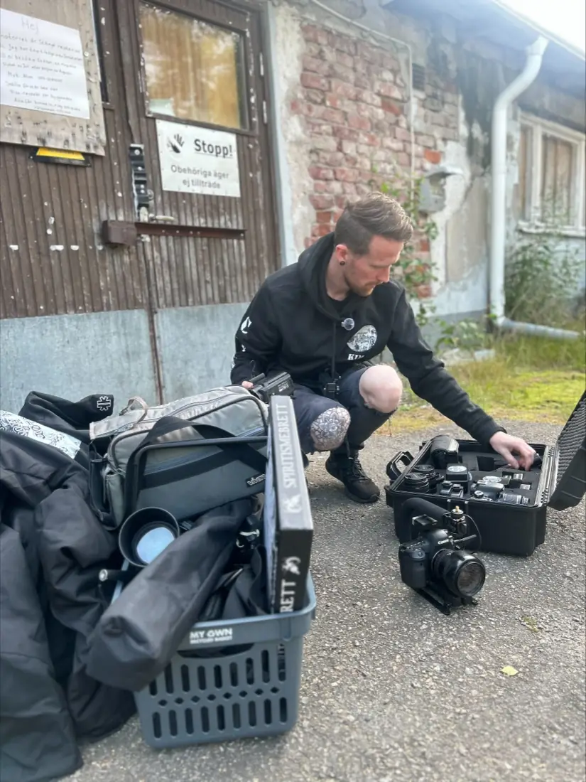 Kim unpacking cameras and measuring equipment outside the sanatorium’s back door